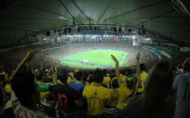 Brazil's supporters celebrate after winning the penalty shoot-out of the Rio 2016 Olympic Games men's football gold medal match between Brazil and Germany at the Maracana stadium in Rio de Janeiro on August 20, 2016. AFP PHOTO / Johannes EISELE)