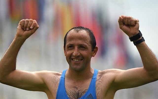 Jordan's Methkal Abu Drais celebrates crosssing the finish line of the Men's Marathon athletics event during the Rio 2016 Olympic Games at the Sambodromo in Rio de Janeiro on August 21, 2016. (AFP PHOTO / OLIVIER MORIN)