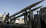Members of the al-Qassam Brigades, the armed wing of the Hamas movement, display Qassam rockets during an anti-Israel military parade marking the second anniversary of the killing of Hamas's military commanders Mohammed Abu Shamala and Raed al-Attar on August 21, 2016, in Rafah in the southern Gaza Strip. (AFP/Said Khatib)