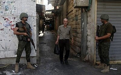 Members of the Palestinian security forces stand guard as they patrol the West Bank city of Nablus on August 23, 2016 during ongoing clashes between Palestinian gunmen and security forces. (AFP PHOTO / JAAFAR ASHTIYEH)