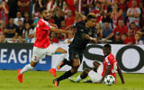 Hapoel's Ben Bitton, left, tries to tackle Celtic's Scott Sinclair, center, during the UEFA Champions League group stages play-off football match between Celtic and Hapoel Beersheba at the Turner Stadium in the southern Israeli city of Beersheba on August 23, 2016. (Gil Cohen-Magen/AFP)