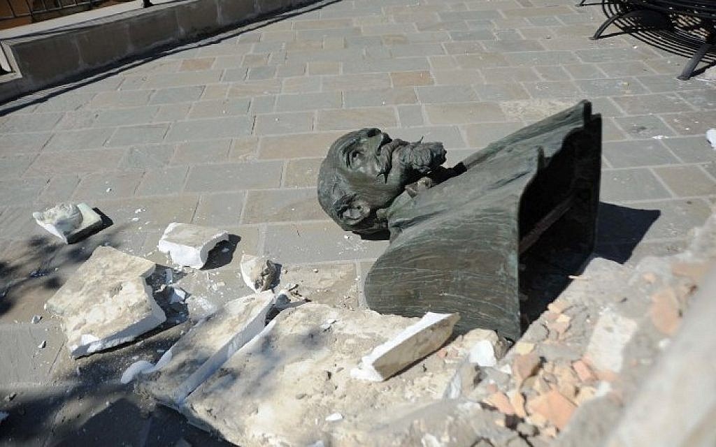 This picture taken on August 24, 2016, shows a broken statue lying on the ground in Accumoli after a strong earthquake hit central Italy.
A powerful pre-dawn earthquake devastated mountain villages in central Italy on August 24, 2016, leaving at least 38 people dead and dozens more injured, trapped or missing. Scores of buildings were reduced to dusty piles of masonry in communities close to the epicentre of the quake, which had a magnitude of between 6.0 and 6.2, according to monitors.
 / AFP PHOTO / MARCO ZEPPETELLA