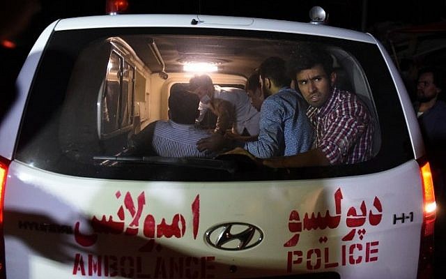 An injured man lies on a stretcher in an ambulance near the site of an explosion that targeted the elite American University of Afghanistan in Kabul on August 24, 2016. (AFP/ WAKIL KOHSAR)