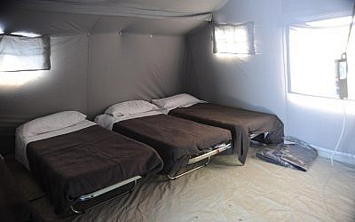 A picture taken in Pescara del Tronto, central Italy on August 25, 2016 shows beds inside a tent of a temporary camp, a day after a 6.2-magnitude earthquake struck the region killing over 200 people. (AFP PHOTO/MARCO ZEPPETELLA)