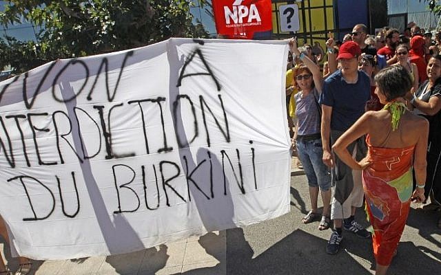 People, gathered for New Anti-Capitalist Party (NPA) summer meeting, hold a banner reading "Against forbidding the wearing of the burkini" as they march in front of Port-Leucate city hall to protest against the municipal ban forbidding the wearing of Burkinis, on August 25, 2016. (Raymond Roig/AFP) People, gathered for New Anti-Capitalist Party (NPA) summer meeting, hold a banner reading "Against forbidding the wearing of the burkini" as they march in front of Port-Leucate city hall to protest against the municipal ban forbidding the wearing of Burkinis, on August 25, 2016. (Raymond Roig/AFP)
