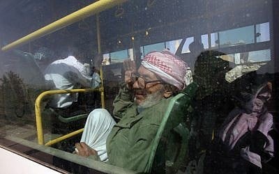 An elderly man is seen gesturing inside a bus, as they are being evacuated from the town of Daraya outside the capital Damascus on August 26, 2016, under a deal agreed between the government and opposition fighters after a four-year army siege. (AFP PHOTO/Youssef KARWASHAN)
