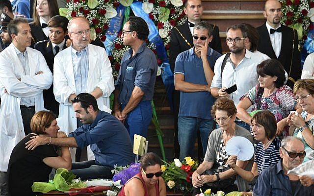 People attend a funeral service for victims of the Italian earthquake, at a gymnasium arranged in a chapel of rest on August 27, 2016, in Ascoli Piceno, three days after a 6.2-magnitude earthquake struck the region killing some 290 people. (AFP PHOTO/ALBERTO PIZZOLI) People attend a funeral service for victims of the Italian earthquake, at a gymnasium arranged in a chapel of rest on August 27, 2016, in Ascoli Piceno, three days after a 6.2-magnitude earthquake struck the region killing some 290 people. (AFP PHOTO/ALBERTO PIZZOLI)