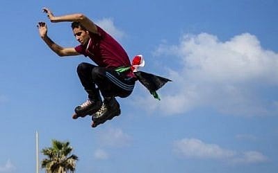A young Palestinian roller-skates on the corniche in Gaza City on August 27, 2016. (AFP PHOTO / MAHMUD HAMS)