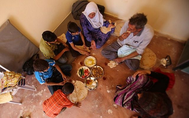 A Syrian family, who has been evacuated from the town of Daraya, share a breakfast upon their arrival at a government reception center in the government-held town of Hrajela in Western Ghouta, outside Damascus, August 27, 2016. (AFP/Youssef KARWASHAN) A Syrian family, who has been evacuated from the town of Daraya, share a breakfast upon their arrival at a government reception center in the government-held town of Hrajela in Western Ghouta, outside Damascus, August 27, 2016. (AFP/Youssef KARWASHAN)
