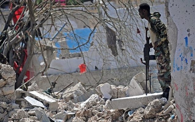 A member of Somalia's security services patrols the scene of a suicide car bomb blast on August 30, 2016 in Mogadishu, Somalia. (AFP/Mohamed Abdiwahab) A member of Somalia's security services patrols the scene of a suicide car bomb blast on August 30, 2016 in Mogadishu, Somalia. (AFP/Mohamed Abdiwahab)