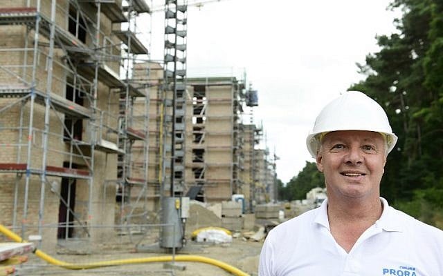Werner Jung, sales representative of Irisgerd real estate agency posing at the construction site for luxury apartments at the heritage-protected Prora Complex in Prora, near Binz, on the island of Ruegen, August 18, 2016. (AFP PHOTO / TOBIAS SCHWARZ).