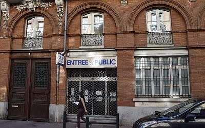 A woman walks in front of a closed Police station where a police officer was stabbed, in Toulouse, on August 30, 2016 (AFP PHOTO / PASCAL PAVANI)