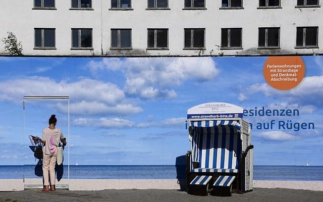 An advertising banner in front of the heritage-protected Prora Complex that is being turned into luxury apartments in Prora, near Binz, north-eastern Germany, August 17, 2016 . (AFP PHOTO / TOBIAS SCHWARZ).