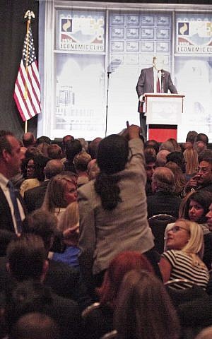 A protester heckles Republican presidential candidate Donald Trump as he delivers an economic policy at the Detroit Economic Club in Detroit Michigan, August 8, 2016. (Bill Pugliano/Getty Images/AFP)