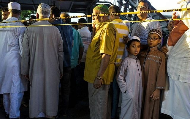 People gather for a demonstration near a crime scene where the leader of a New York City mosque and an associate were fatally shot in a brazen daylight attack as they left afternoon prayers Saturday, August 13, 2016. Police said 55-year-old Imam Maulama Akonjee and his 64-year-old associate, Tharam Uddin, were shot in the back of the head as they left the Al-Furqan Jame Masjid mosque in the Ozone Park section of Queens. (AP Photo/Craig Ruttle) People gather for a demonstration near a crime scene where the leader of a New York City mosque and an associate were fatally shot in a brazen daylight attack as they left afternoon prayers Saturday, August 13, 2016. Police said 55-year-old Imam Maulama Akonjee and his 64-year-old associate, Tharam Uddin, were shot in the back of the head as they left the Al-Furqan Jame Masjid mosque in the Ozone Park section of Queens. (AP Photo/Craig Ruttle)