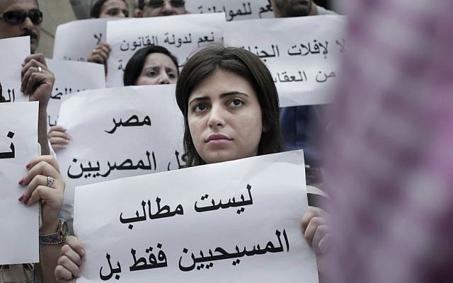 An Egyptian woman holds a sign in Arabic that reads, "the demands are not only for Christians but for all Egyptians," during a protest against the latest surge of assaults on Christians in Cairo, Egypt, Saturday, Aug. 13, 2016. (AP Photo/Nariman El-Mofty) An Egyptian woman holds a sign in Arabic that reads, "the demands are not only for Christians but for all Egyptians," during a protest against the latest surge of assaults on Christians in Cairo, Egypt, Saturday, Aug. 13, 2016. (AP Photo/Nariman El-Mofty)