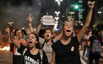 Demonstrators shout slogans against acting Brazil's President Michel Temer during a rally in support of Brazil's suspended President Dilma Rousseff in Sao Paulo, Brazil, August 29, 2016. (AP Photo/Andre Penner)