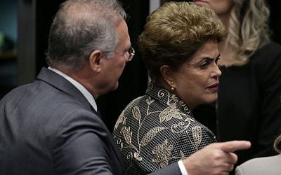 Brazil's Senate leader Renan Calheiros points to an exit as suspended President Dilma Rousseff leaves the Senate chambers after addressing the lawmakers, August 29, 2016. (AP Photo/Eraldo Peres)