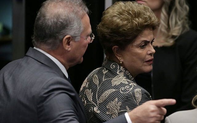 Brazil's Senate leader Renan Calheiros points to an exit as suspended President Dilma Rousseff leaves the Senate chambers after addressing the lawmakers, August 29, 2016. (AP Photo/Eraldo Peres) Brazil's Senate leader Renan Calheiros points to an exit as suspended President Dilma Rousseff leaves the Senate chambers after addressing the lawmakers, August 29, 2016. (AP Photo/Eraldo Peres)