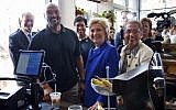 US Democratic presidential candidate Hillary Clinton joined by (from left), Washington City Council member Jack Evans, Uprising Muffin Company owner Donnie Simpson, Washington Mayor Muriel Bowser and Del. Eleanor Holmes Norton, D-D.C., at the muffin store in Washington, DC, on June 10, 2016. (AP/Alex Brandon, File)