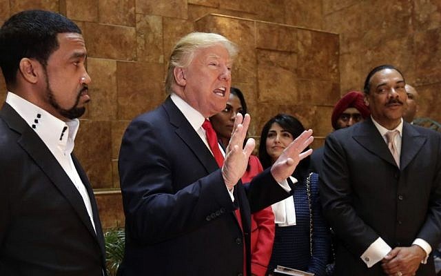 In this April 18, 2016 file photo, Pastor Darrell Scott listens at left as Republican presidential candidate Donald Trump speaks in Trump Tower building in New York. (AP/Richard Drew, File) In this April 18, 2016 file photo, Pastor Darrell Scott listens at left as Republican presidential candidate Donald Trump speaks in Trump Tower building in New York. (AP/Richard Drew, File)