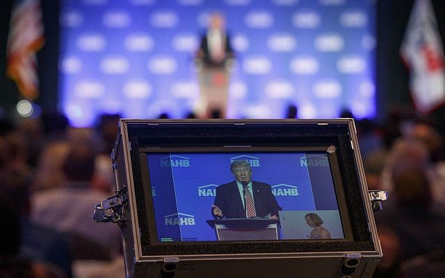 Republican presidential candidate Donald Trump is captured in a video monitor as he speaks to the National Association of Home Builders, Thursday, Aug. 11, 2016, in Miami Beach, Florida. (AP Photo/Evan Vucci)