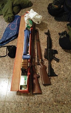 An M-16 assault rifle, shotgun and hunting rifle discovered by IDF troops in Khirbat Abu Lahm, northwest of Jerusalem, during a raid on August 10, 2016. (IDF Spokesperson's Unit)