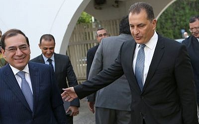 Cyprus' Energy Minister Yiorgos Lakkotrypis, right, welcomes Egypt's Petroleum Minister Tarek el-Molla following their meeting at the Cyprus' Energy ministry in Nicosia, Cyprus, Wednesday, August 31, 2016.  (AP Photo/Petros Karadjias)
