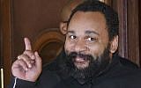 French comedian Dieudonne M'Bala M'Bala gestures to the media as he leaves a Paris court house, February 4, 2015.  (AP Photo/Michel Euler)
