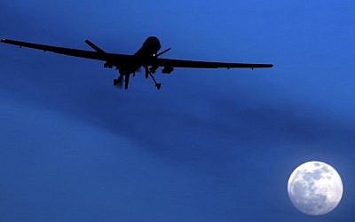 File: An unmanned US Predator drone flies over Kandahar Air Field, southern Afghanistan, on a moon-lit night, on January 31, 2010. (AP Photo/Kirsty Wigglesworth, File)