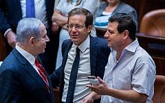 In this undated photo, Prime Minister Benjamin Netanyahu (L) speaks with Leader of the Zionist Union party Isaac Herzog (C) and Leader of the Joint (Arab) List, Ayman Odeh in the Knesset. (Yonatan Sindel/Flash90)