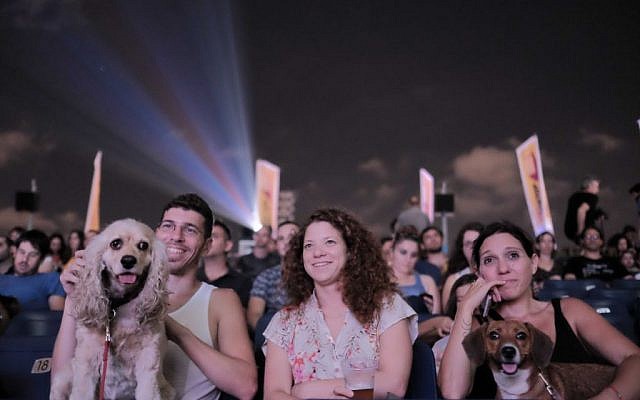Israelis and their dogs attend a special rooftop screening of the movie 'The Secret Life of Pets' at the Azrieli Center in Tel Aviv on July 11,2016. (Photo by Tomer Neuberg/Flash90)
