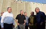 Prime Minister Benjamin Netanyahu (2nd L) and Defense Minister Avigdor Liberman (L), along with MK Avi Dichter and IDF Chief of Staff Gadi Eisenkot, visit a new section of the security barrier between Israel and the West Bank near Tarqumiyah on July 20, 2016. (Haim Zach/GPO)