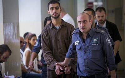 Ali Abu Hassan, a Palestinian student from a village outside of Hebron, walks through a Jerusalem court on August 2, 2016, before being indicted for attempting to carry out a terror attack on the Jerusalem light rail in July. (Yonatan Sindel/Flash90)