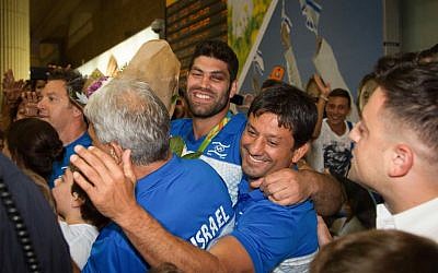 Or Sasson, center, is greeted by supporters at Ben-Gurion Airport on August 15, 2016. (Roy Alima/Flash90) Or Sasson, center, is greeted by supporters at Ben-Gurion Airport on August 15, 2016. (Roy Alima/Flash90)