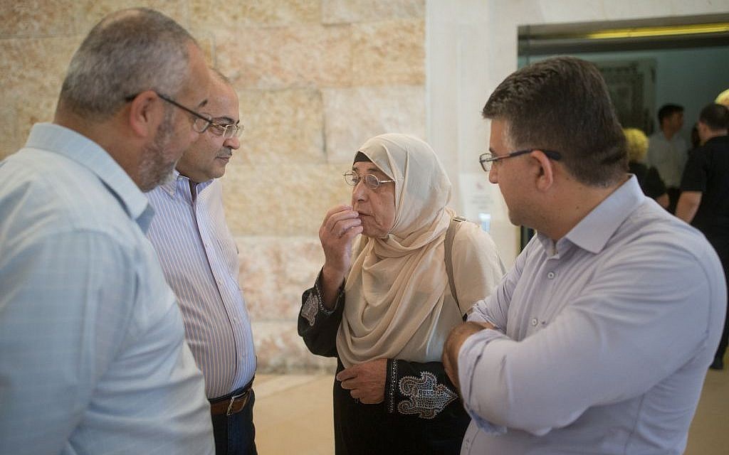 Mother of hunger-striking Palestinian prisoner Bilal Kayed speaks with MK Ahmad Tibi at the Supreme Court in Jerusalem ahead of a court hearing on August 22, 2016. (Photo by Yonatan Sindel/Flash90)