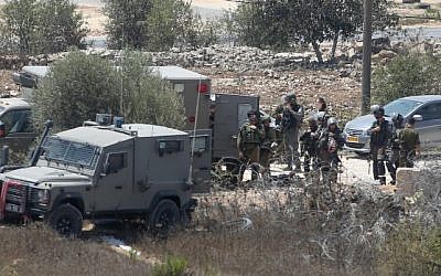 Israeli security forces at the scene where Iyad Hamad, a Palestinian man was shot dead by Israeli soldiers after running towards a guard post near the West Bank village of Silwad, August 26, 2016. (Flash90) Israeli security forces at the scene where Iyad Hamad, a Palestinian man was shot dead by Israeli soldiers after running towards a guard post near the West Bank village of Silwad, August 26, 2016. (Flash90)