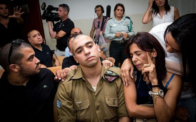Elor Azaria, center, during a hearing in his manslaughter trial at a military court in Jaffa, August 28, 2016. (Miriam Alster/Flash90) Elor Azaria, center, during a hearing in his manslaughter trial at a military court in Jaffa, August 28, 2016. (Miriam Alster/Flash90)