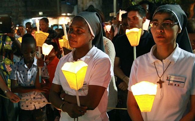 Nuns attend a candlelight procession for the Virgin Mary at the sanctuary of Lourdes, southwestern France, Sunday, Aug. 14, 2016. (AP Photo/Bob Edme)