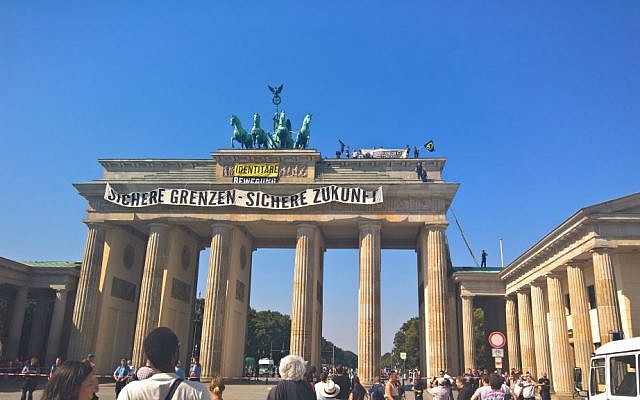 Anti-Islam activists stage a demonstration atop Berlin’s Brandenburg Gate on August 27, 2016. The banner reads : Secure Borders - Secure Future. (AP/Frank Jordans)