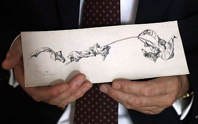 Dr. Johann Schiller holds a replica of a nearly 200-year-old drawing, Wednesday, Aug. 17, 2016, in Washington, after the original was returned to his family from the National Gallery of Art's collection decades after his relative was forced to sell it during World War II because of her Jewish heritage. 'A Branch with Shriveled Leaves' by the German artist Julius Schnorr von Carolsfeld had been owned by the artist's descendants until Dr. Marianne Schmidl sold it under duress in 1939. (AP/Jacquelyn Martin)
