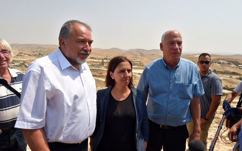 Defense Minister Avigdor Liberman, left, Minister of Social Equality Gila Gamliel and Agriculture Minister Uri Ariel speak to reporters following a tour of Israel's Bedouin communities in the Negev desert on August 29, 2016. (Ariel Hermoni/Defense Ministry)