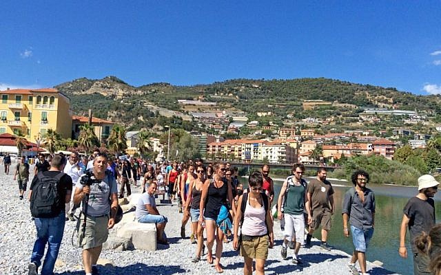 A No Borders group of activists walk along the seaside during a spontaneous march in Ventimiglia, Italy, Sunday, August 7, 2016. (Fabrizio Tenerelli/ANSA via AP)