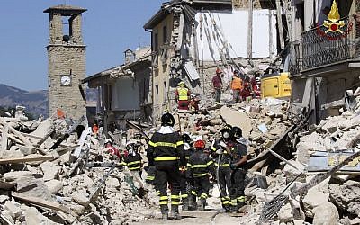 Rescuers work amid collapsed building in Amatrice, central Italy, Thursday, Aug. 25, 2016. Rescue crews raced against time Thursday looking for survivors from the earthquake that leveled three towns in central Italy and Italy once again anguished over trying to secure its medieval communities built on seismic lands. (Italian Firefighters Vigili del Fuoco via AP)