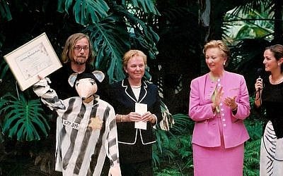 Luc Descheemaeker (back row, left) receiving an award from Belgium’s Queen Paola (in pink), in 2002 for his children’s puppet theater play based on Art Spiegelman’s cartoon Holocaust memoir 'Maus.' (Courtesy of Sint-Jozefs Institute/JTA)