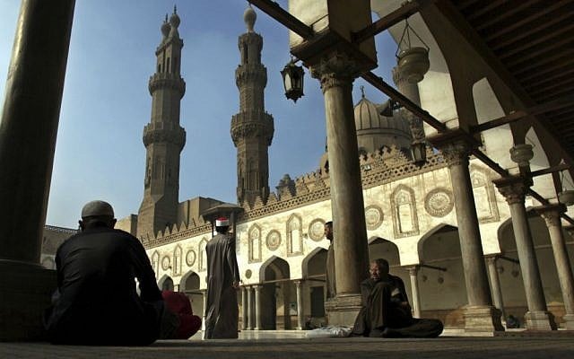 In this Dec. 28, 2012 file photo, Muslim men wait for the Friday noon prayer at Al-Azhar Mosque in Cairo, Egypt. (AP Photo/Khalil Hamra, File)