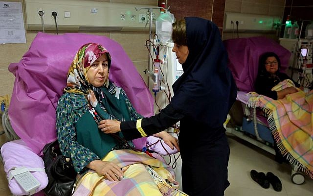Zahra Hajikarimi uses a kidney dialysis machine as a nurse attends to her, at a clinic in downtown Tehran, Iran, August 6, 2016. (AP/Ebrahim Noroozi)