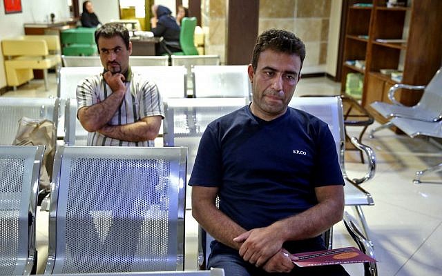 Sajjad Ghanbari, right, waits for a medical exam as part of the process of selling his kidney in a clinic in downtown Tehran, Iran, June 6, 2016. (AP/Ebrahim Noroozi)