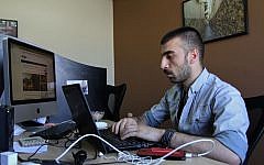 Syrian Mohammed al-Haj Ali messages eyewitnesses in Syria for the news organization Syria Direct, July 18, 2016. (AP/Layla Quran)