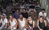 In this Saturday, Sept. 1, 2012, file photo, Syrian prisoners sit in a courtroom before their release in Damascus, Syria. (AP Photo/Bassem Tellawi, File)